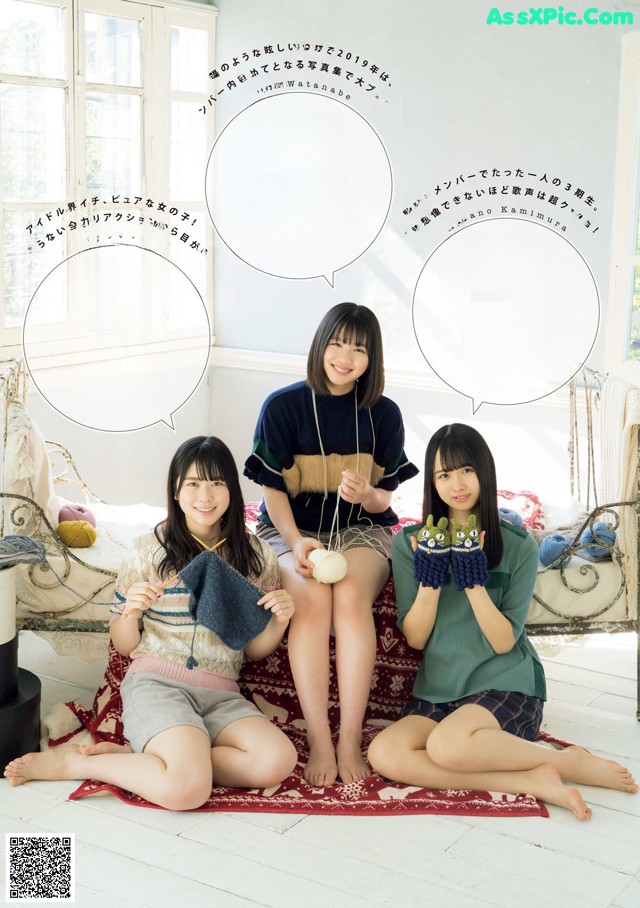 A group of young women sitting on top of a bed.