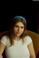 A woman sitting on a couch wearing a blue headband.