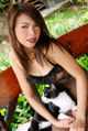 A woman sitting on a bench with a cat.