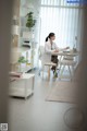 A woman sitting at a desk in an office.