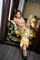 A woman sitting on a couch in a room.